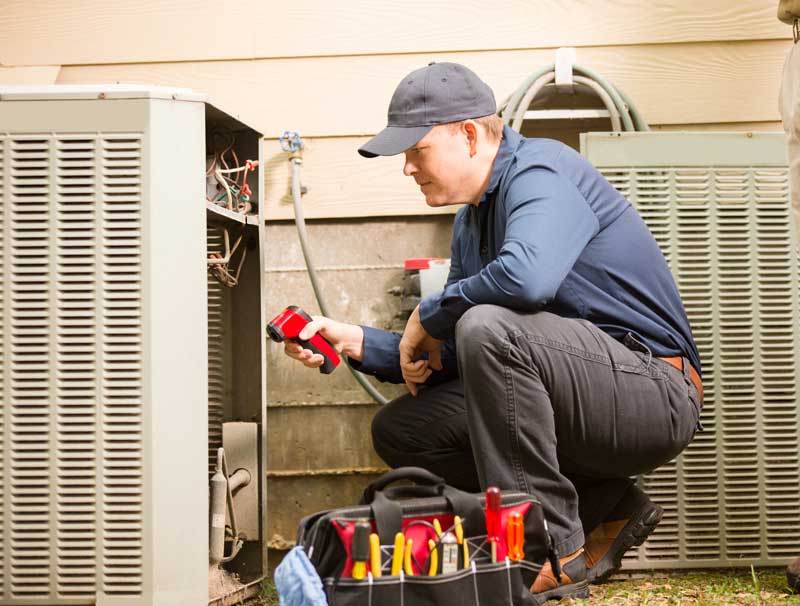 Air conditioner repairmen work on home unit