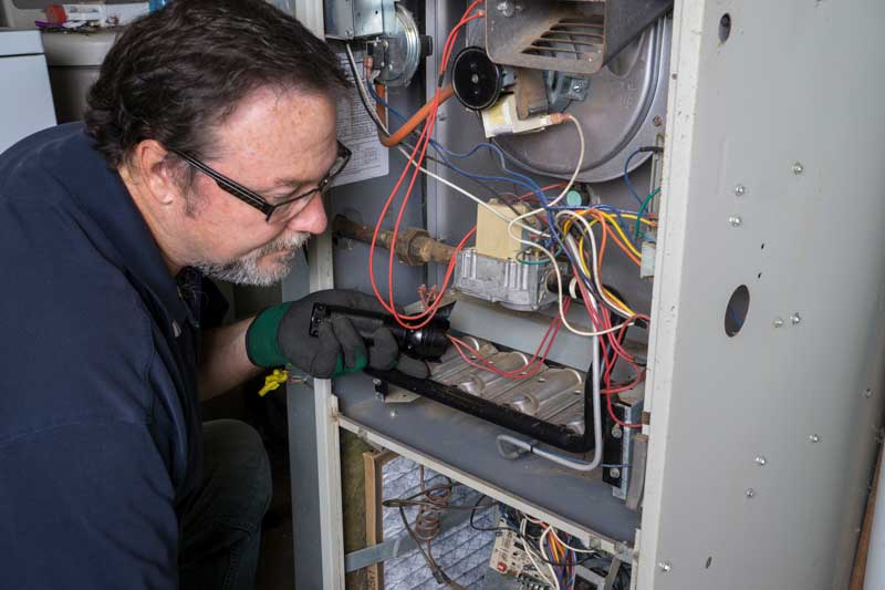 Technician running maintenance or Repairs on a furnace